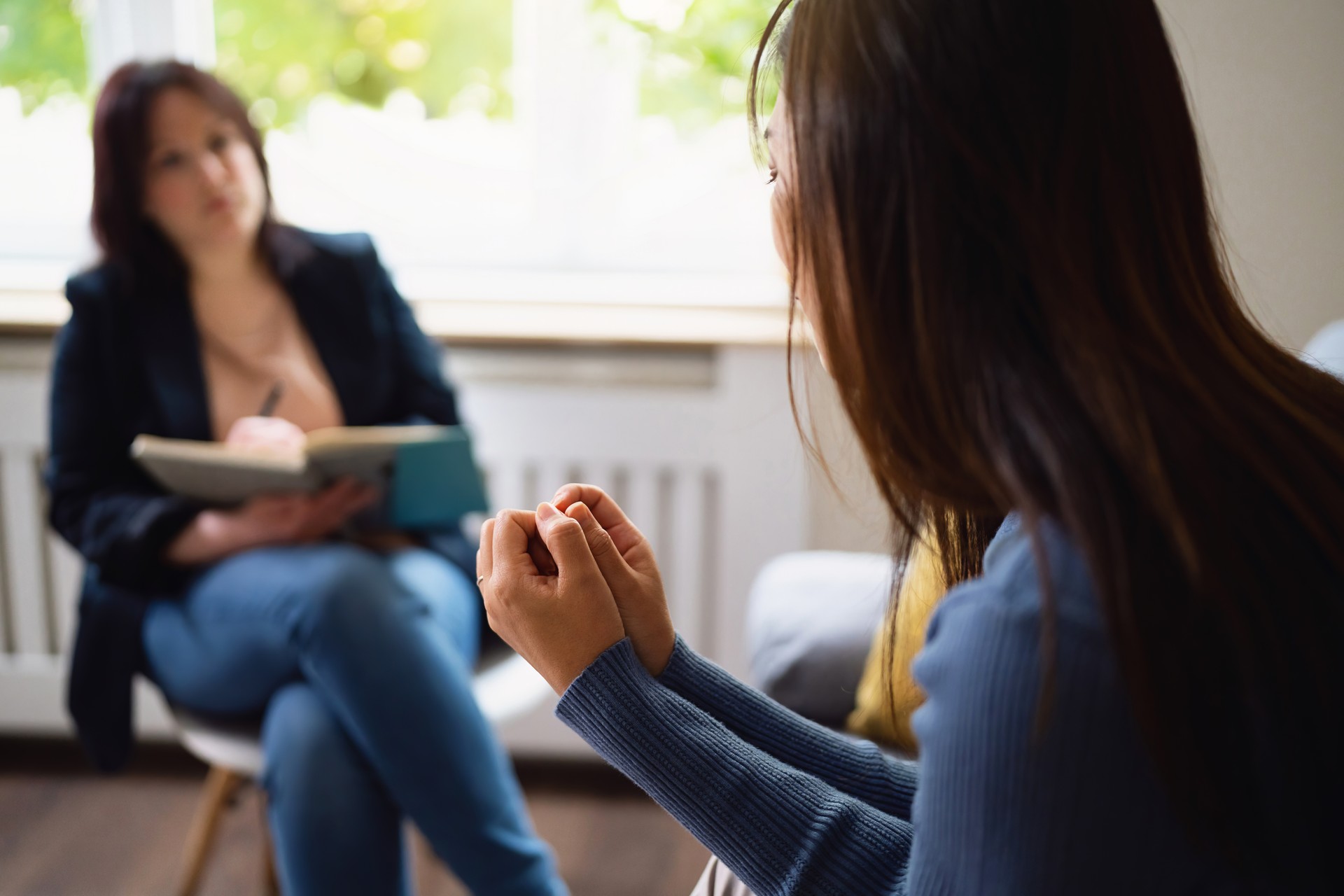 Distraught woman Japanese ethnicity, at the therapy